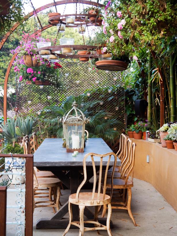 Add flavor to your garden, and make it your own. This outdoor chandelier of candles and hanging plants sets a playful mood and brings the space to life. Mix and match a worn wooden table with some antique metal chairs, or march a row of potted plants down a ledge. Most importantly, have fun.