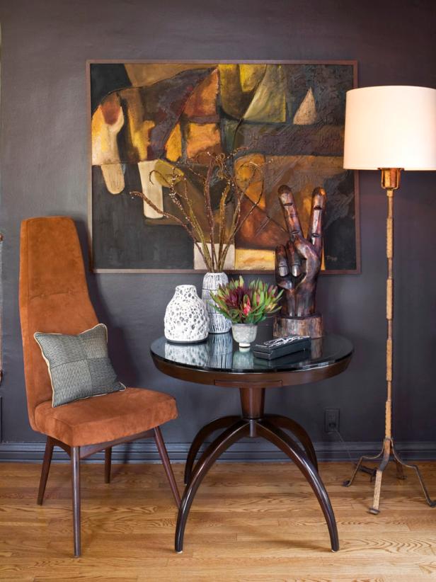 Transitional Seating Area With Rust-Colored Chair and Colorful Art