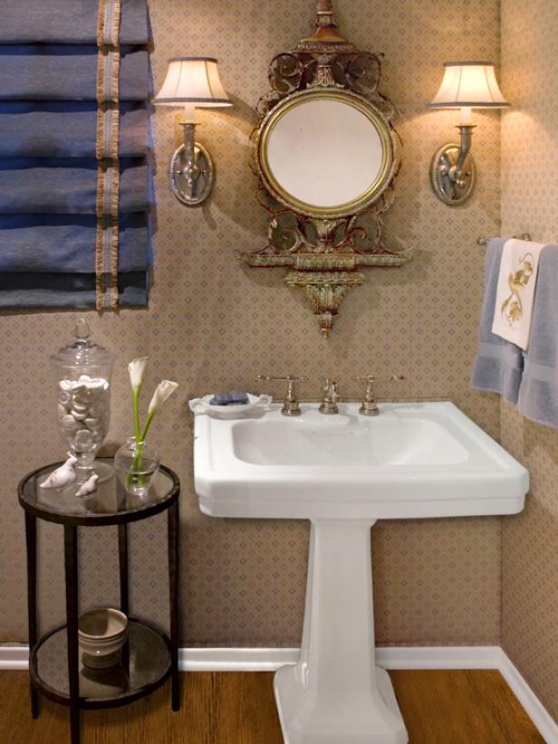 gold faucets for bathroom Elegant powder room with stunning pedestal
sink and ornate mirror