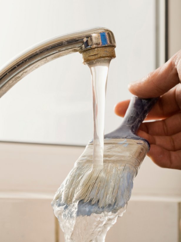 Use soap and water to clean latex paint off the brush immediately after painting. If the paint dries on the brush, you'll need special solvents to remove it. If your house is on a public sewer system, you can clean the brushes in your sink, but be careful not to dispose of paint in an area where it might seep into the groundwater.