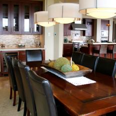 Dining Room With Rustic Table and Black Leather Chairs