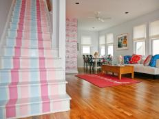 Pastel-Striped Pink and Blue Stairway and Adjoining Living Room