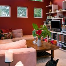 Cozy Red Living Room with White Shelving and Cozy Sectional