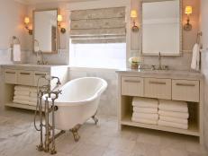 Beige Bathroom With White Freestanding Tub and Neutral Vanities