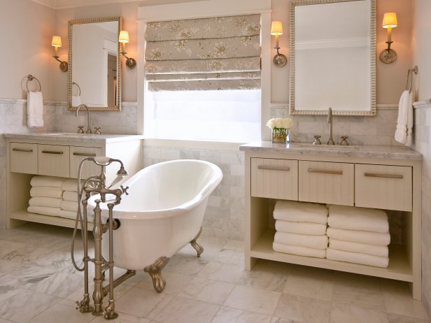 Beige Bathroom With White Freestanding Tub and Neutral Vanities