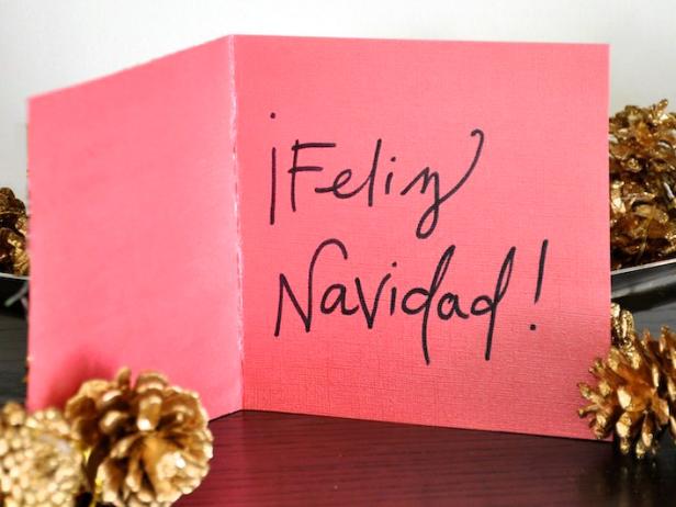 This pink card wishes its recipient a merry Christmas.
