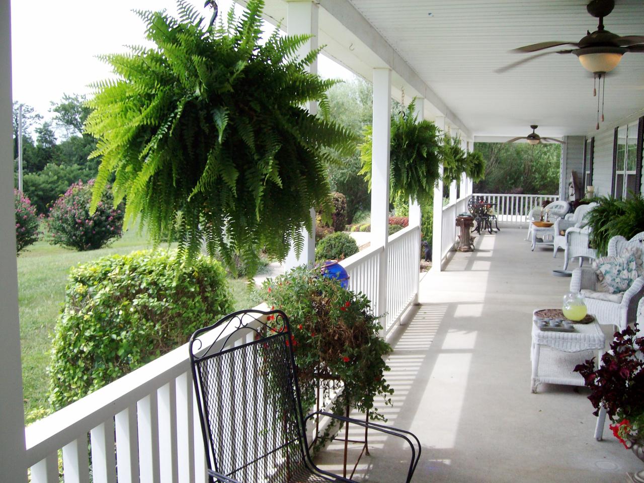 Large White Country Porch With Wicker Furniture Hgtv