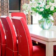 Straight-Backed Red Dining Chairs With White Flowers