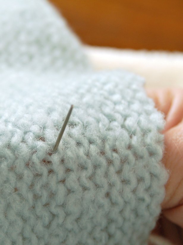 it's important to use the appropriate size needle to complete the embellishments on your no-knit Christmas sweater. An upholstery needle is recommended for thick yarn.