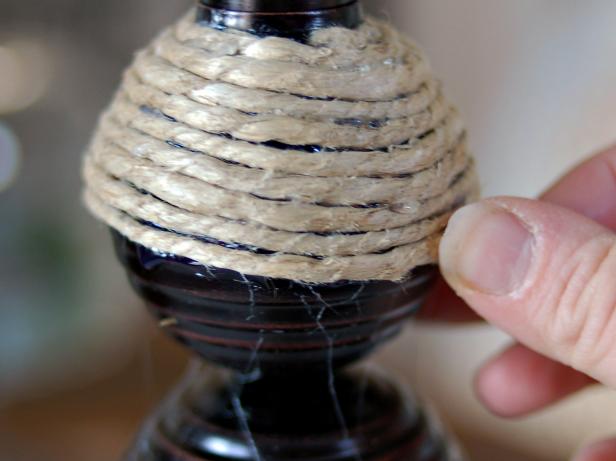 Twine can be applied in one long piece until the entire lamp base is covered. Cut the twine with scissors when you reach the bottom of the lamp.