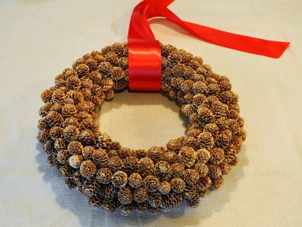 Tie Red Ribbon on Pine Cone Wreath