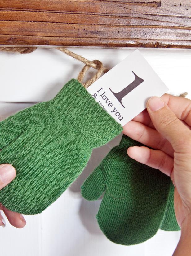 Use flat-headed thumbtacks to hang the mitten garland from your mantel. Slide a paper number into each mitten.