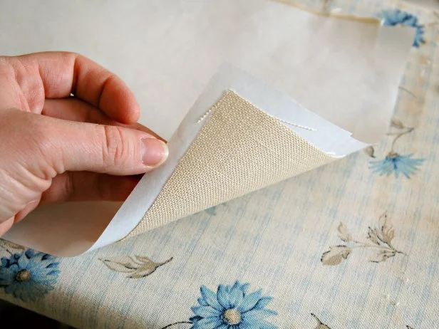 Press paper onto fabric using an iron set on high until they are fused.