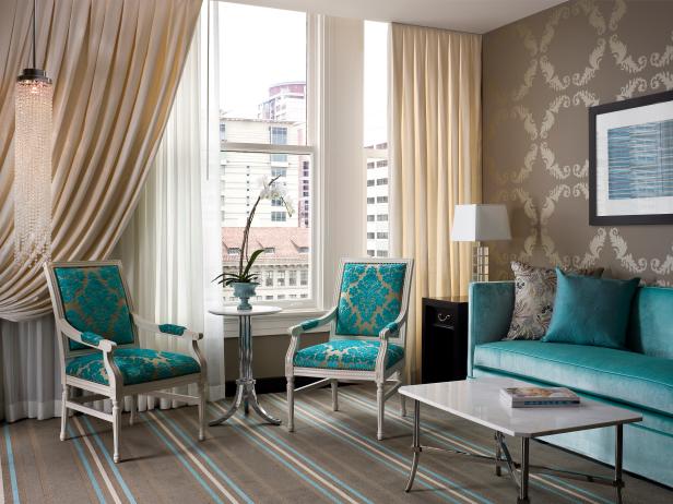 Neutral Living Room With Turquoise Furniture and Wallpaper 