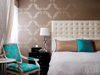 Taupe Art Deco Bedroom With Cream Headboard and Vibrant Blue Accents