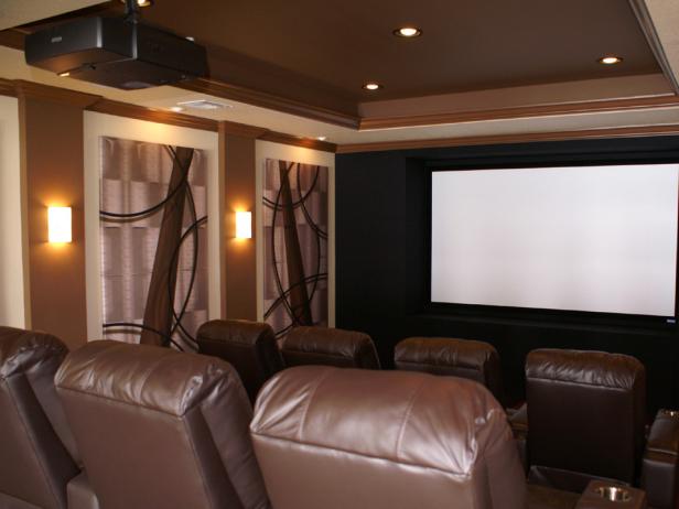 Once your drywall is painted, you can hang your speakers, projector, and screen. In a theater of 20 by 13 feet, the ideal screen size is 110-120 inches. For a professional feel, frame the screen with a proscenium – a set of black acoustic panels that hide the left, right, and center speakers.Camouflage the remaining speakers with acoustic panels that double as artwork. These panels can be printed with custom designs, including family photos or favorite movie posters.