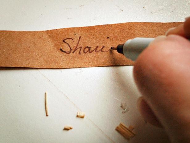Write guest's name on card using a fine-tipped permanent marker.