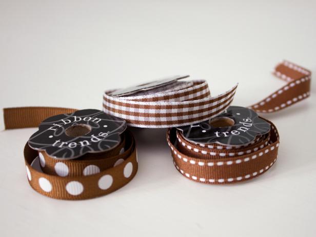 Select spools of ribbon that are 3/8 inch wide or smaller. The ribbon will be secured in the pumpkins' grooves, so the smaller the better. Tip: Stick with neutral colors or black-and-white ribbon for a look that can be displayed from early fall through Thanksgiving.
