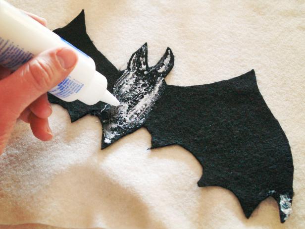 Fabric bats are glued to a Halloween applique pillow.
