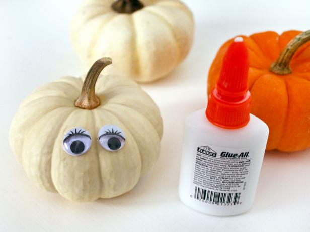 Attach one set of googly eyes to each pumpkin. Tip: Place the pumpkins in the dishes before you attach the eyes so you can make sure they're positioned correctly.