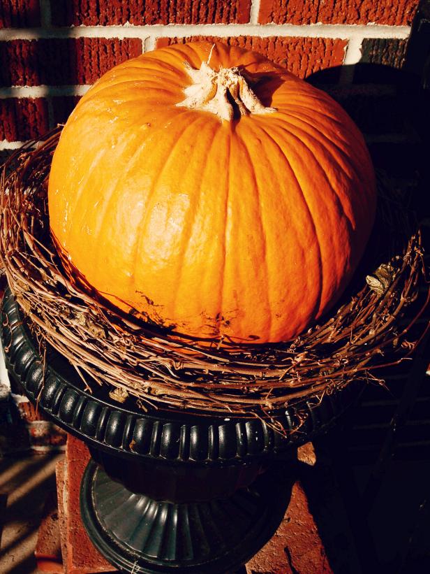 Place pumpkin in grapevine wreath nest.