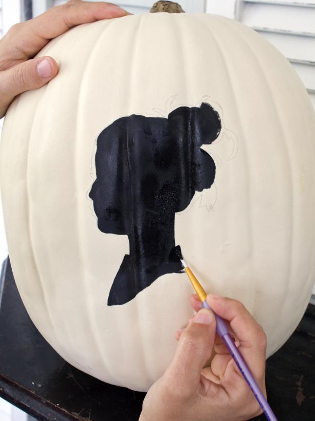 Use a small-tipped detail brush around the edges of the silhouette to clean up the design.
