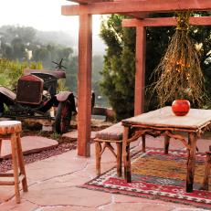 Southwestern Outdoor Dining Room With Colorful Patterned Rug