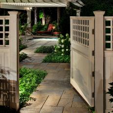 Traditional White Entry Gate and Pergola-Covered Patio with Pool