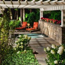 Traditional Stone Patio With Spa and Neutral Pergola