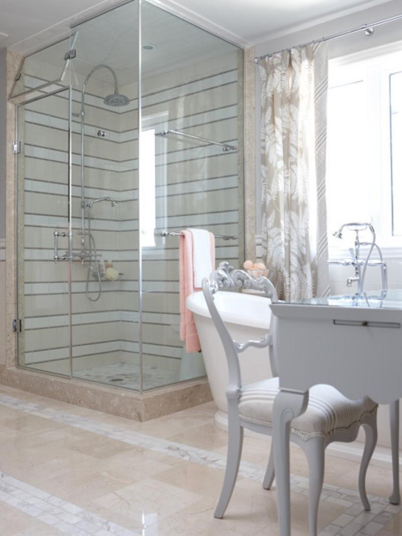 Beige Bathroom WIth Tile Floor, White Vanity and Glass Shower
