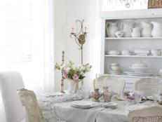 Shabby Chic Dining Room With Open Cabinet and Dishware