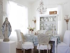 Ruffled tablecloth, distressed chairs create shabby chic look.