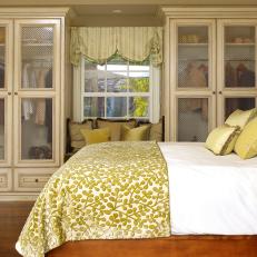 Traditional Yellow Bedroom With Glass Front Armoires