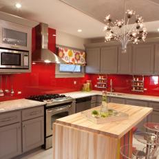 Gray and Red Kitchen With Eye-Catching Chandelier