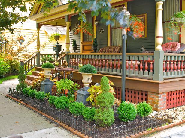 Victorian Front Porch With Colorful Molding and Small Garden Space