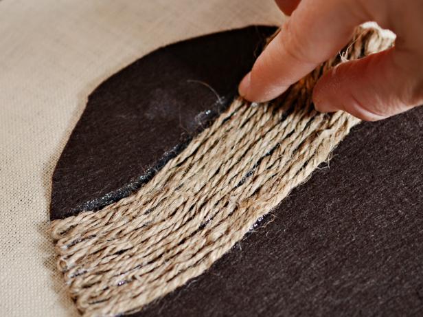 Stick jute twine to hot glue. Hold in place until glue cools. Continue this process, weaving jute twine back and forth until entire cap is covered.