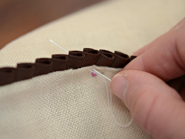 Thread an all-purpose needle with cream all-purpose cotton thread and knot at end. Use a running stitch to sew pillow closed (Image 4). Remove pins. Note: Pillow should be spot-cleaned only.