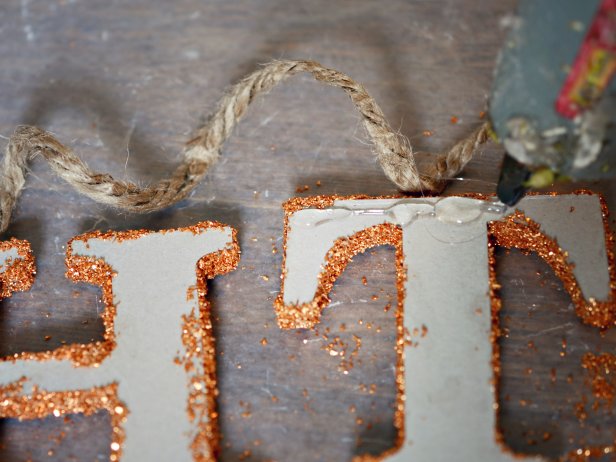 Once dry, use hot glue gun to affix letters to hemp twine. Space the letters approximately one half-inch apart. Leave a four-inch space between words. Loop twine on each end to hang.