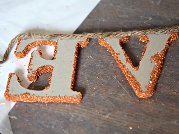 Once dry, use hot glue gun to affix letters to hemp twine. Space the letters approximately one half-inch apart. Leave a four-inch space between words. Loop twine on each end to hang.