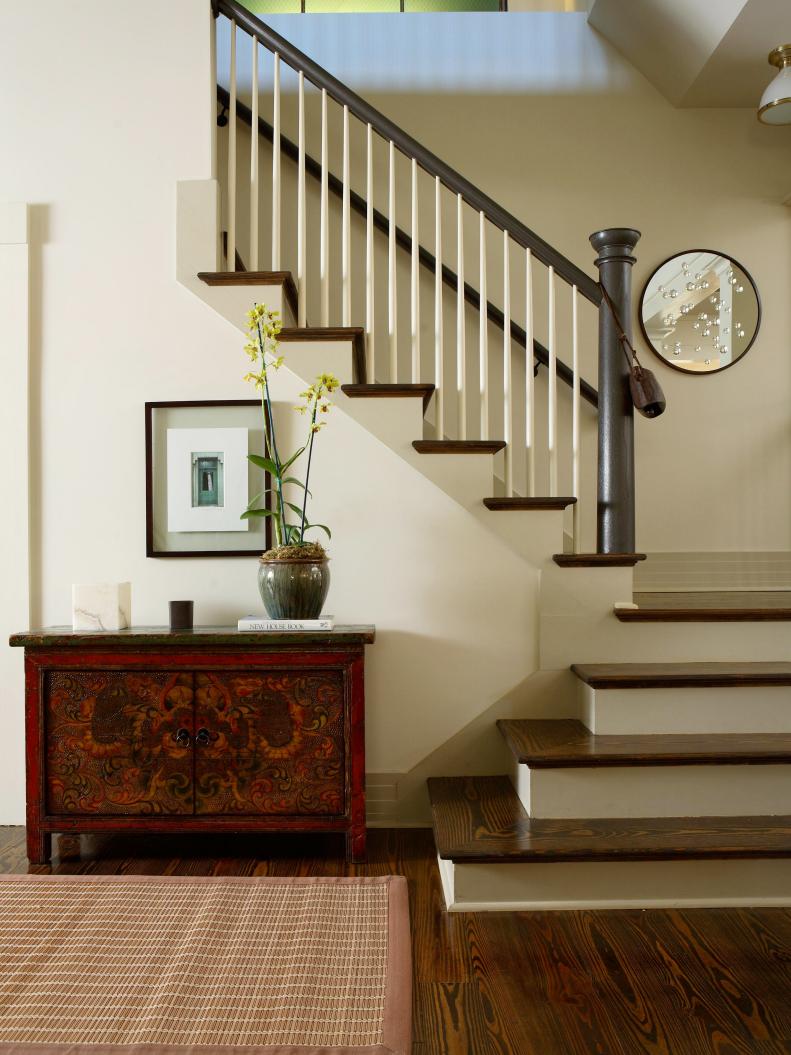 Transitional Staircase With Wood Console, Area Rug and Round Mirror 