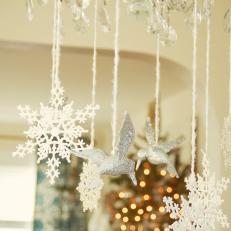 Snowflakes and Birds Hanging From Chandelier 