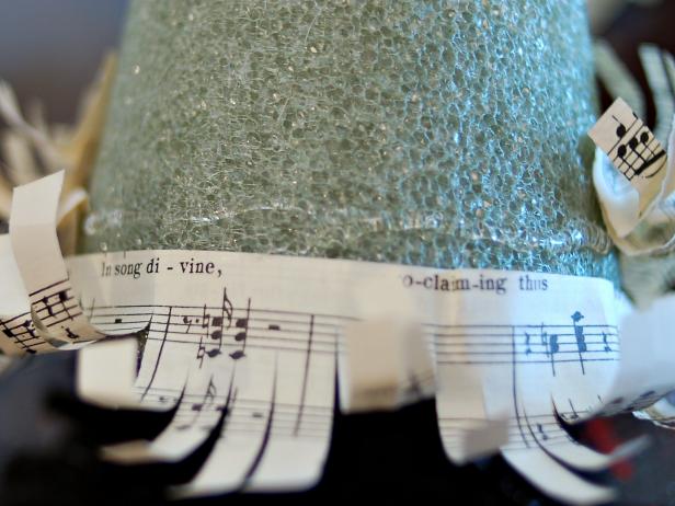Hot glue is applied to this foam Christmas tree for sheet music strips.