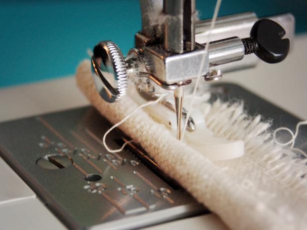 Cut cotton cording to length, so it will wrap around entire table once. From the remaining unused twill, cut a strip of fabric that is 2 inches wide and same length as cord. Wrap around cording and sew with zipper foot.