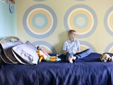 Pastel Bedroom With Bull's Eye Wall Paintings and Blue Bedding