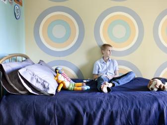 Pastel Bedroom With Bull's Eye Wall Paintings and Blue Bedding
