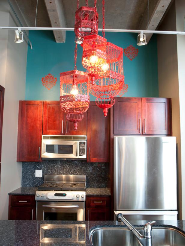 teal kitchen with eclectic chandelier made with red birdcages