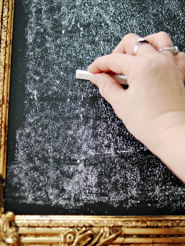 Rub entire chalkboard with the side of a piece of chalk. This will season the chalkboard and prevent writing from being burned into the surface. Erase chalkboard with a wet paper towel for a clean look or with a dry one for a smeared, vintage look.