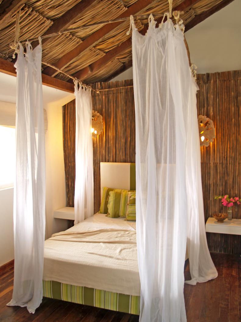 Bedroom With Bamboo Wall and Thatched Ceiling