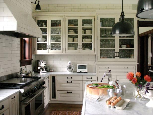Kitchen With White Tile Walls, White Cabinetry and Gray Counters