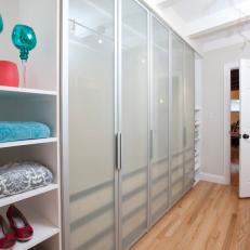 White Walk-In Closet With Frosted Glass Cabinets